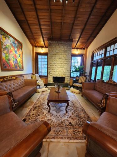 a large living room with couches and a fireplace at The Villa at Galapitiyaya Estate in Haputale