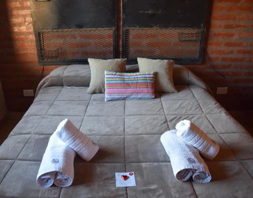 a bed with two pairs of socks on it at Apart-Maragato in Patagones