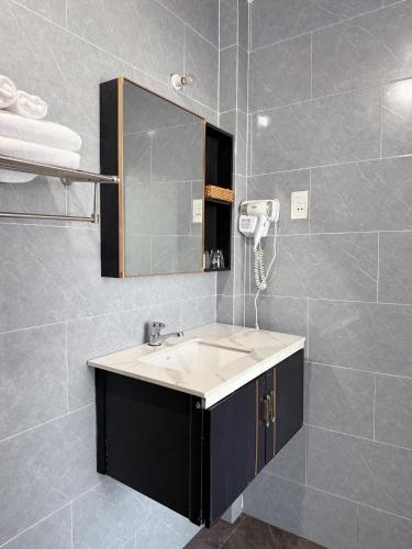 a bathroom with a sink and a mirror at Nhat Lan Resort in Phú Quốc