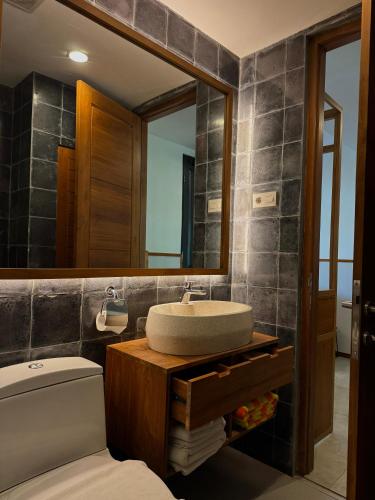 a bathroom with a sink and a mirror at YATS Colony in Yogyakarta