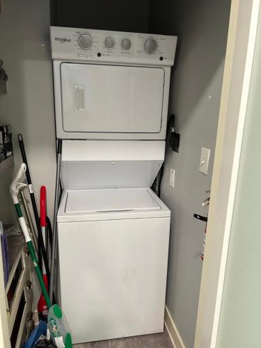 a white refrigerator and stove in a small kitchen at HomeStay B&B in Boston - 3 locations in Dorchester in Boston