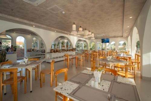 a restaurant with tables and chairs and a cafeteria at The Up Hotel Phu Quoc Island - The Poolside Escape in Phu Quoc