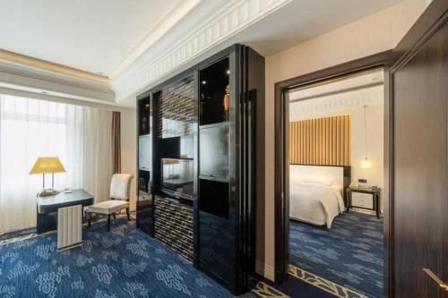 a hotel room with a bed and a desk at Tongxiang Inspirock Hotel in Jiaxing