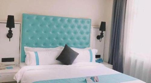 a bedroom with a large bed with a blue headboard at Xana Hotelle Xi'an GONG IP South Gate of Zhonglou in Xi'an