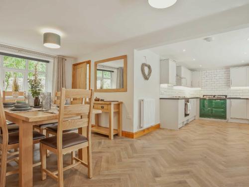 a kitchen and dining room with a table and chairs at The Barn in Carnforth