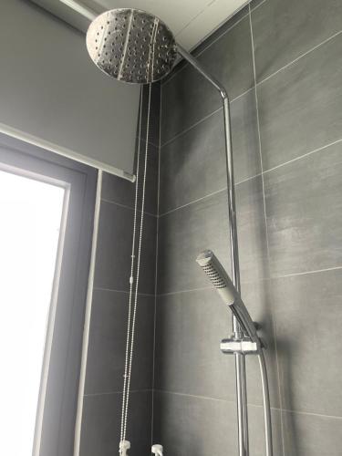 a shower with a shower head in a bathroom at Đảo Ngọc Homestay - Grand World Phú Quốc in Phu Quoc