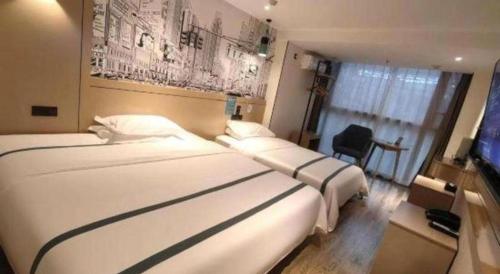a hotel room with two beds and a chair at City Comfort Inn Kunming High Speed Railway South Station Yongxin Harvard in Kunming