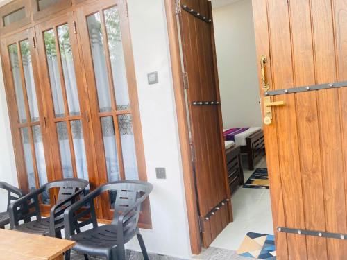 a room with a table and chairs and a door at River Nature Park in Polonnaruwa