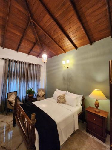 a bedroom with a large bed and a window at The Villa at Galapitiyaya Estate in Haputale