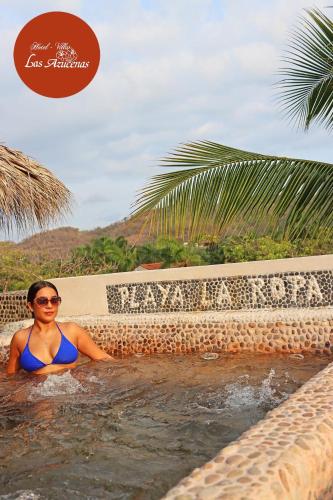 a woman in a swimming pool at a resort at Hotel Villas Las Azucenas in Zihuatanejo