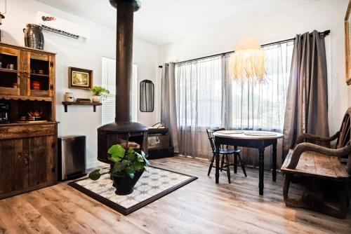 a living room with a wood stove and a table at Budget Studio Near Paseo Art & Uptown Okc #03b in Oklahoma City