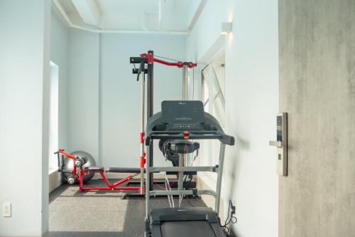 a room with a gym with a treadmill at The Up Hotel Phu Quoc Island - The Poolside Escape in Phu Quoc