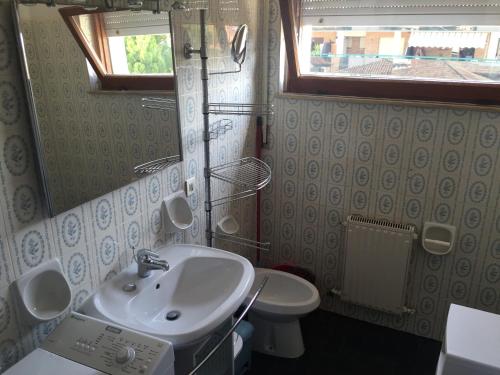 a bathroom with a sink and a toilet at Ponente Central Apartment in Senigallia