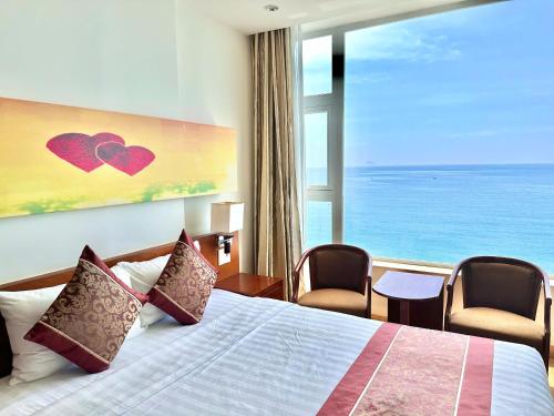 a hotel room with a bed and a large window at Nha Trang Wonderland Hotel in Nha Trang
