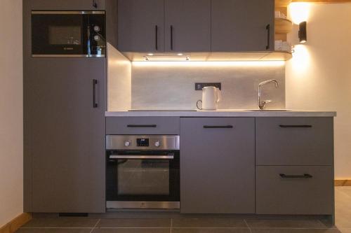 a kitchen with a sink and a stove at chalet au pied des pistes in Les Deux Alpes