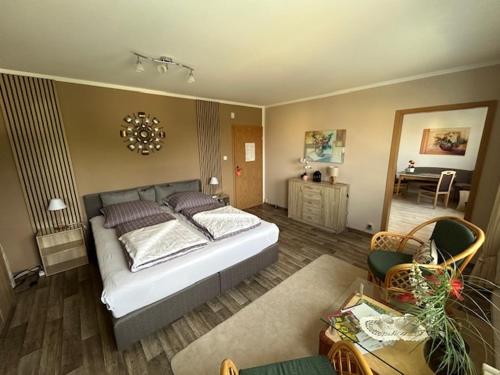 a bedroom with a bed and a living room at Ferienwohnung Quedlinburg OT Gernrode Harz in Gernrode - Harz