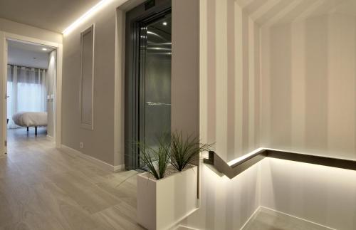 a hallway with a stairwell with a potted plant at Hotel Lemik in Alsasua