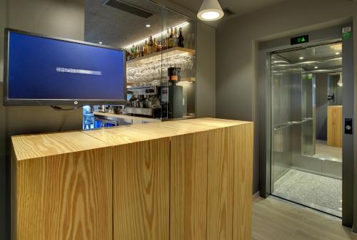 a bar with a large tv on top of it at Hotel Lemik in Alsasua