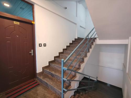 a staircase leading up to a door in a building at Queens INN in Kodungallūr