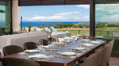 a long table with wine glasses and a view of the ocean at ❤PiH❤ Hale Moana Heated Private Pool Spa Detached Ohana Suite in Waimea