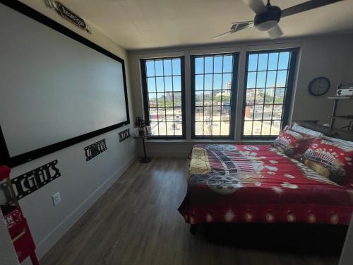a bedroom with a bed and a large window at Deep Ellum Theatre Suite - The Black Collection in Dallas