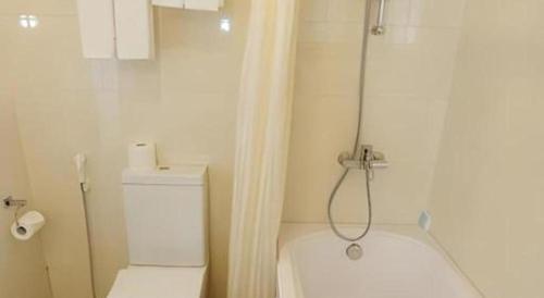 a white bathroom with a shower and a toilet at Lenid Hotel Tho Nhuom in Hanoi