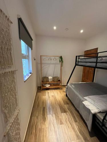 a bedroom with a bunk bed and a wooden floor at Lushoto Loria in Lushoto