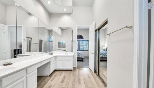 a bathroom with two sinks and a large mirror at TPC Golf Course North Scottsdale in Scottsdale