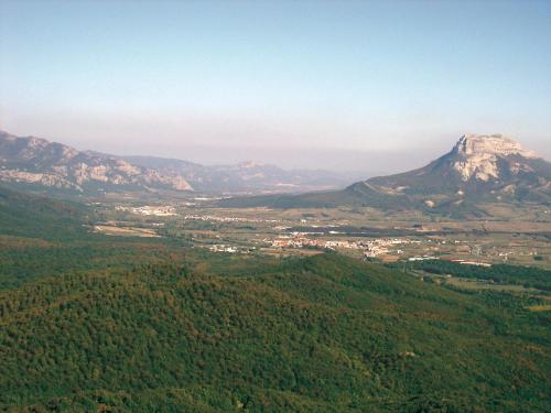 a view of a mountain with a town and trees at Hotel Lemik in Alsasua