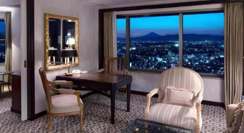 a room with a desk and chairs and a large window at Yokohama Royal Park Hotel in Yokohama