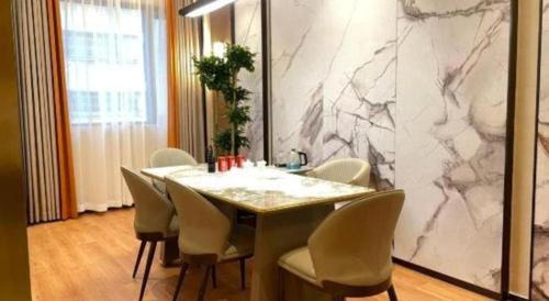 a dining room with a marble table and chairs at Chaozhou Hotel in Chaozhou