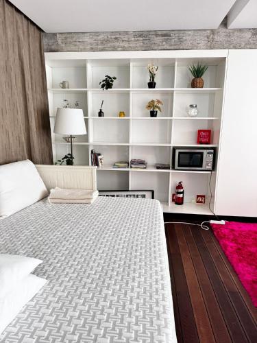 a bedroom with a bed and white shelves at Poolside Suite - Quinta da BellaVista in Santarém