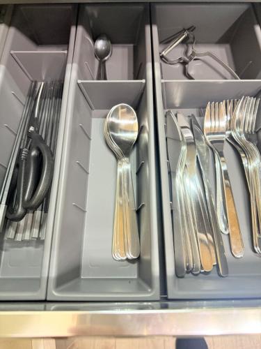 a drawer filled with silver utensils and a spoon at Nakakasai Kodate NKK21 in Tokyo