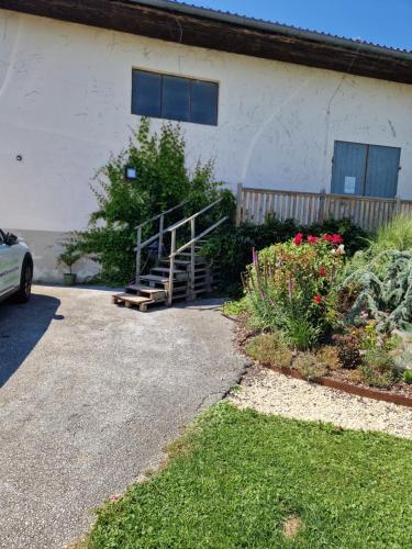 a house with a staircase in front of a yard at Ferienwohnung mit Pool an der Apfelstraße in Puch bei Weiz
