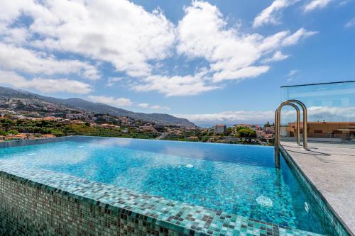 a swimming pool with a view of a city at Casa da Ilha in Funchal