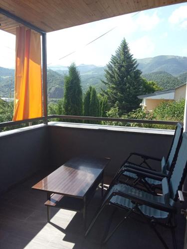 a table and two chairs on a balcony with a view at Sunny Lodge Dilijan in Dilijan