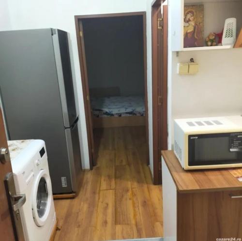 a kitchen with a refrigerator and a microwave at Casa Elena camere de Inchiriat in Bucharest