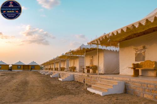 a row of houses on a dirt road at Khamma Ghani Resort with pool Luxury camp in Jaisalmer in Jaisalmer