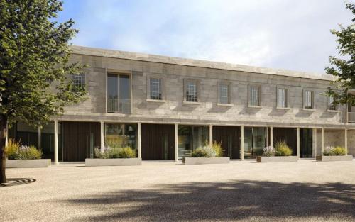 a large stone building with a lot of windows at Historic waterfront factory house Royal William Yd in Plymouth