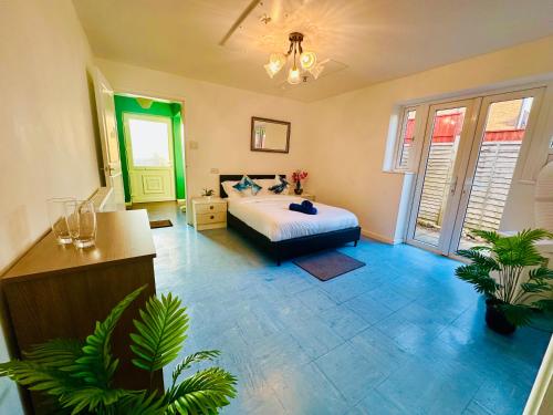 a bedroom with a bed and plants in it at Cozy Comfort Home in Stoke on Trent