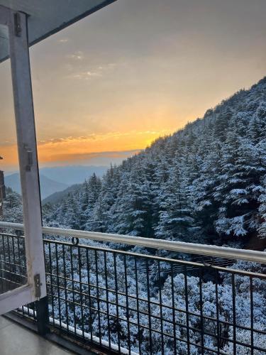 a balcony with a view of a snow covered mountain at Pahadi Zayka Homestay in Chail