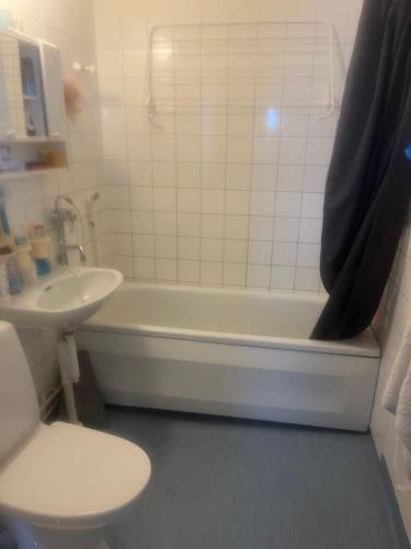 a bathroom with a tub and a toilet and a sink at Nice and comfortable in Norrköping