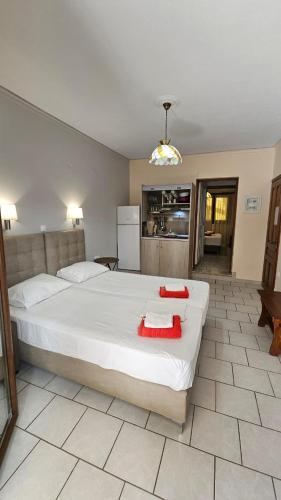 a bedroom with a large bed with red pillows on it at Mavra Studios in Lygia