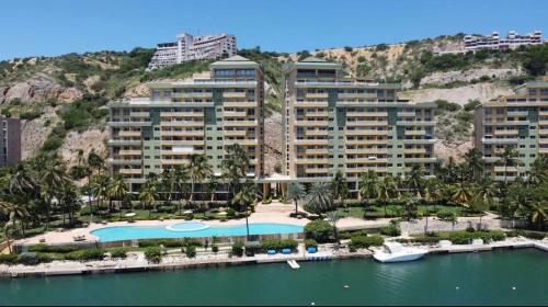 an aerial view of a resort with a swimming pool at Lecheria Oceanfront Escape - Pool, View & Relax in Morro de Barcelona