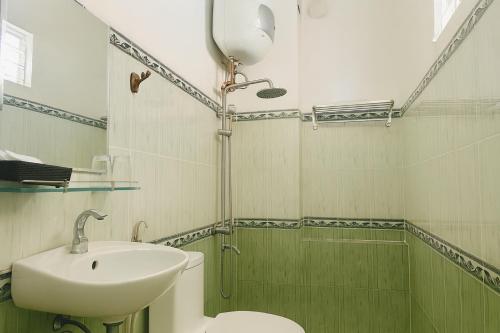 a bathroom with a sink and a toilet and a shower at LE VU HOTEl in Da Lat