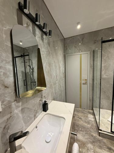 a bathroom with a sink and a mirror at Galactic&Ludmila Suite SPA in Braşov