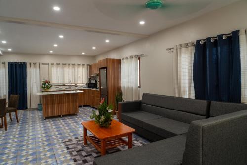 a living room with a couch and a table at Airport Ace Villas in Nadi