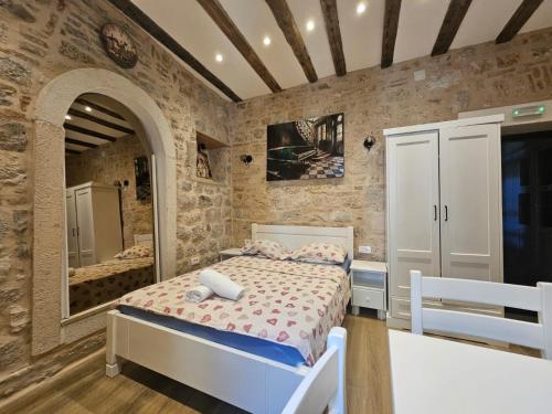 a bedroom with a bed and a mirror at Patrik Patrik in Kotor