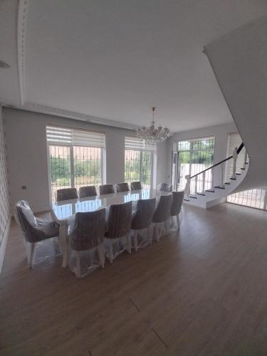 a large room with a long table and chairs at Quba Panoramik Villa in Quba
