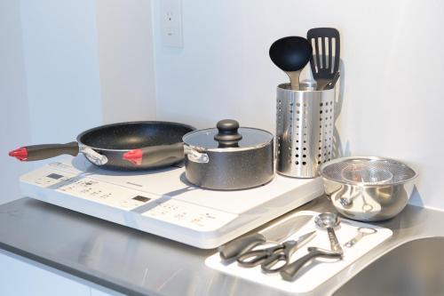 a kitchen counter with a tray with utensils on it at Liberty Place Nakano by Tranova in Tokyo
